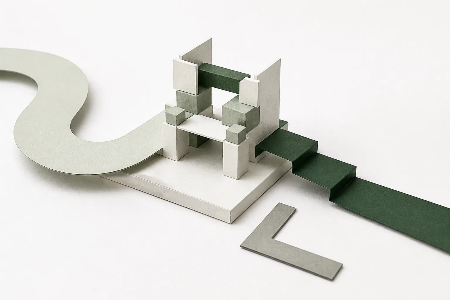 Two paper construction paths leading toward the same modular system on a studio desk